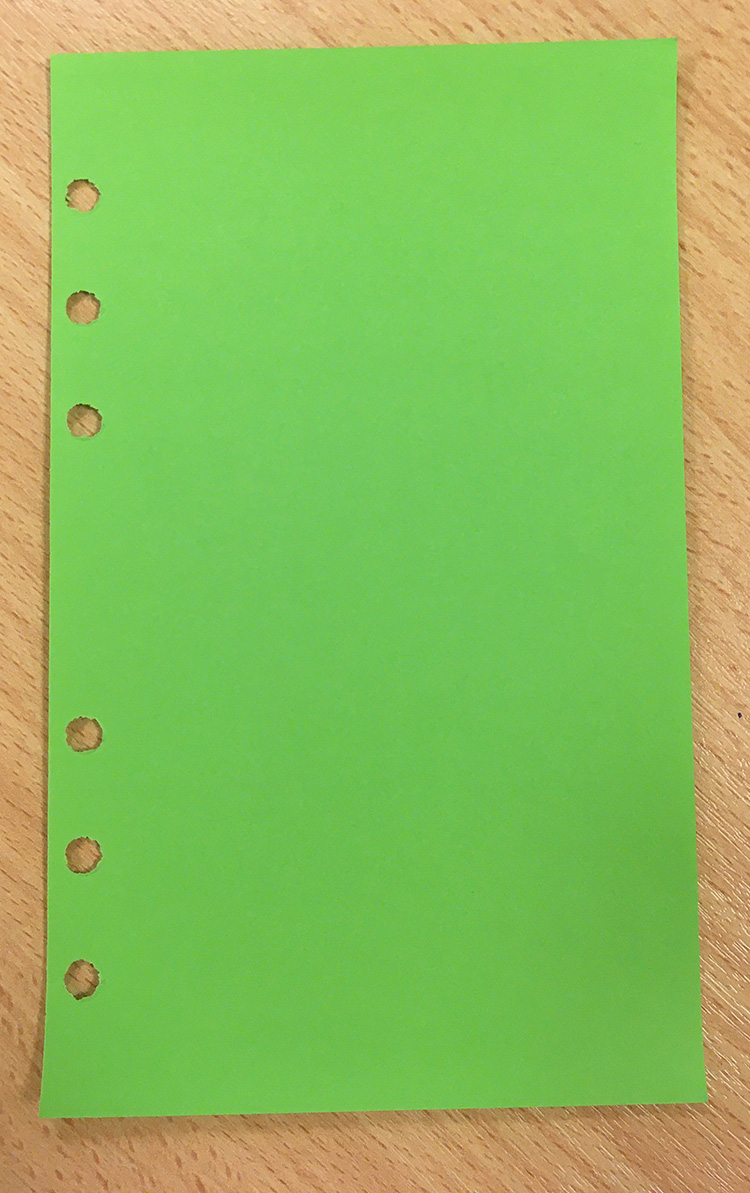 Grönt, tomt Filofaxblad med sex hål i